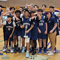Boys Basketball Team behind trophy