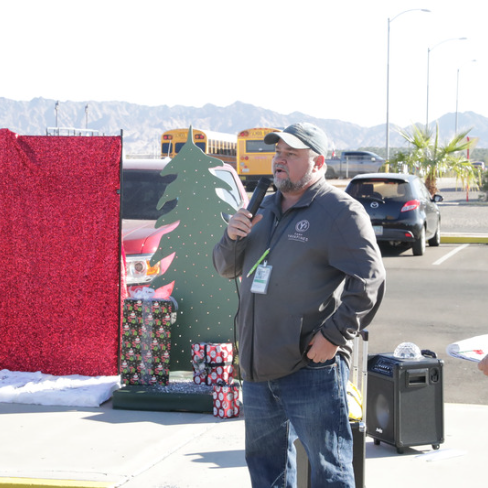 1 teacher talking into a microphone outside